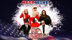 Pop ROCKS tribute band promotional graphic for the Heat Wave Summer Event Series, featuring performers dressed as iconic pop and rock music stars against a backdrop of fireworks and an American flag. The image includes celebrity-inspired costumes, stage microphones, and a patriotic red, white, and blue theme.